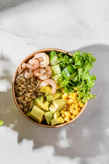 bowl with shrimp and quinoa in an ecological box