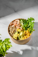 bowl with shrimp and quinoa in an ecological box
