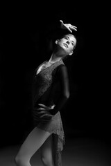 woman figure skater posing on dark background © zhagunov_a
