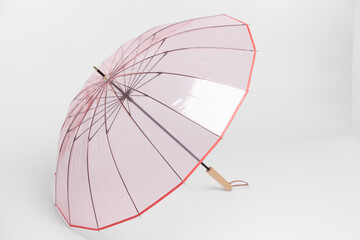 Elegant Pink Umbrella Displayed on a White Surface
