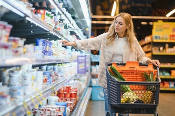 Young cool customer woman wear casual clothes shopping at supermaket store grocery shop buying with...
