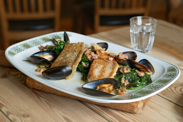 Cooked Cornish sole with mussels, shrimps and spinach served in a lemon butter sauce.