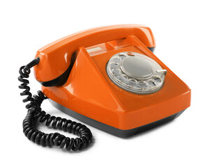 Old orange telephone with rotary dial isolated on white