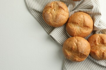 Homemade tasty buns on light table, top view. Space for text
