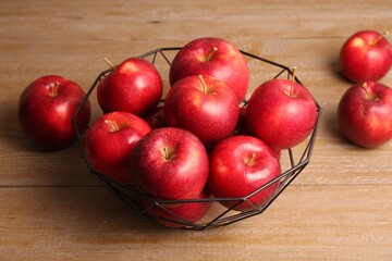 Fresh ripe red apples on wooden table