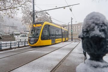 Snowy tram track with tram, buildings in the background, winter, diffused light, Hungary, Budapest, wide angle lens