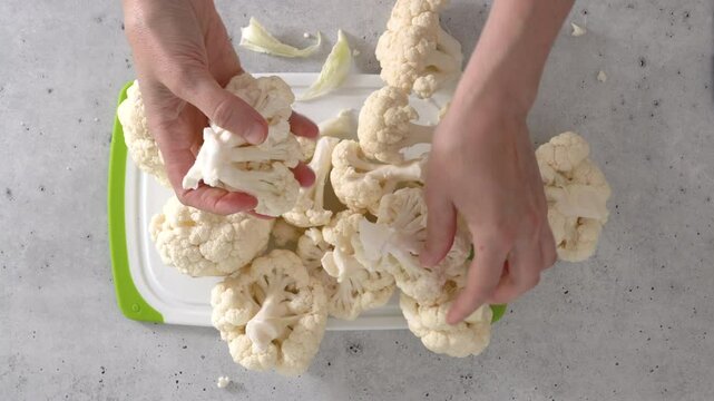 The chef devided cauliflower into florets, the cooking process, view from above. 
