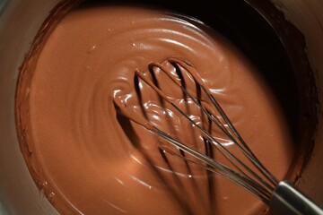 Mixing chocolate dough with whisk, top view
