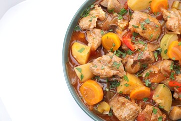 Delicious stew with vegetables isolated on white, top view