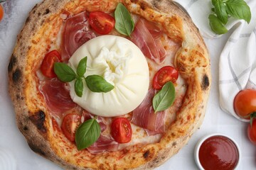 Delicious pizza with burrata cheese served on white table, top view