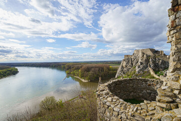Two old bastions of Devin Castle, Danube river in background, slightly cloudy sky, Slovakia, wide...