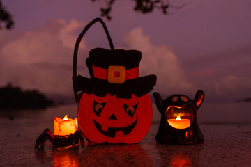 Concept: Halloween beach and ocean background with spider, witch and ghost pumpkin. Dark, scary tone.