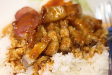 plate of crispy pork rice with sausage