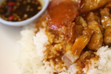 plate of crispy pork rice with sausage