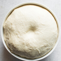 Overhead view of proofed bread dough, Checking if dough is proofed using a finger poke test, process of making bread