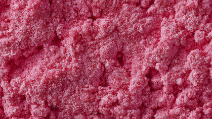 Obraz premium a close-up, top-down view of a small mound of dried raspberry powder, featuring its vibrant pink-red hue