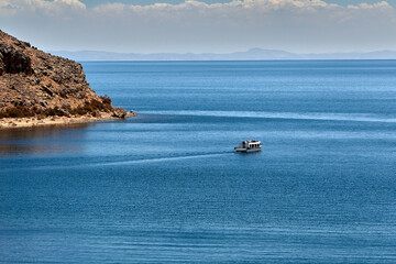 A lone canoe on the vastness of Lake Titicaca, where silence speaks and the world feels endless