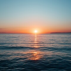 Obraz premium Vibrant sunset on the horizon casting reflections on tranquil ocean waters creating a captivating serene sunset view.
