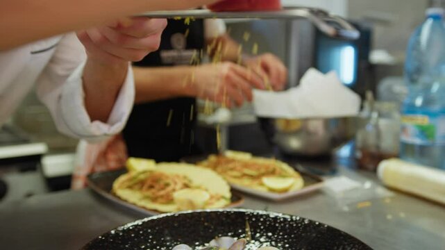 Chef is Grating Bottarga into a Plate of Italian Spaghetti with Clams