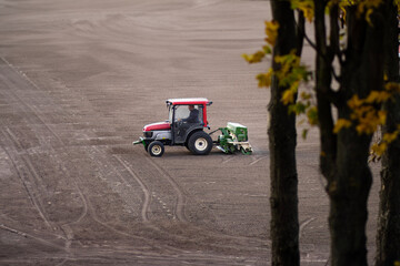 A powerful tractor plowing through a vast field, showcasing agricultural machinery in action, highlighting the beauty of rural landscapes.