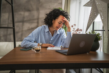 Mature woman work or learn use laptop while have migraine headache