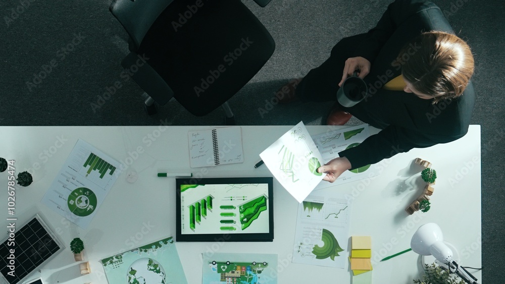 Poster top down view of project manager walking around meeting table with green business element. aerial vi