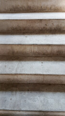 Gray cement stairs. Closeup of concrete stairs without railing, old stairs detail, abstract stone stairs background.