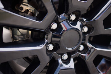 Detailed shot of a sleek black and silver alloy wheel on a motor vehicle