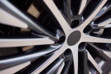 Detailed shot of a sleek black and silver alloy wheel on a motor vehicle
