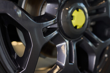 Fototapeta premium Detailed shot of a sleek black and silver alloy wheel on a motor vehicle