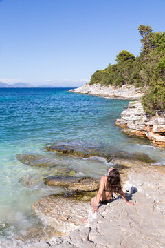 Woman suntanning on a beach in summer, Kefalonia, Greek Islands, Greece