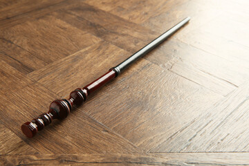One magic wand on wooden table, closeup