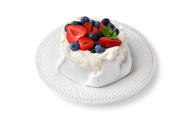 Pavlova cake (meringue dessert) with whipped cream, fresh berries and mint isolated on white
