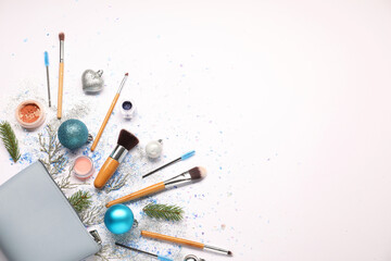 Fototapeta premium Cosmetic bag, makeup brushes, decorative cosmetics and Christmas decor on white background, flat lay. Space for text