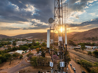 Obraz premium aerial view, cellular antenna at sunset, communications tower, mountain range,