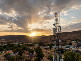aerial view, cellular antenna at sunset, communications tower, mountain range,