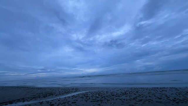 This soothing beach scene captures the calm waves and expansive sky, creating a serene atmosphere. Perfect for those seeking peace and natural beauty by the sea.