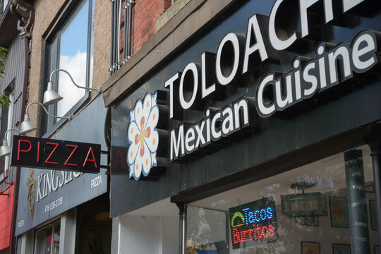 detail of Toloache Mexican Cuisine sign and building exterior at 1128 Queen Street West in Toronto, Canada