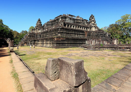 Baphuon,Angkor Thom,Siem Reap,Cambodia - Dcember 15, 2019: Tourists are looking at the ruins of huge stones.