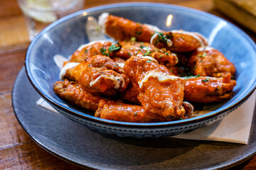 Buffalo Chicken Wings with Ranch Dressing. A close-up shot of delicious buffalo-style chicken wings...