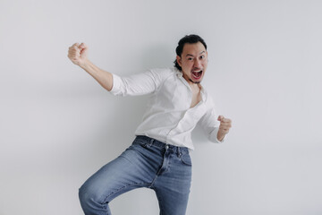 Winner face long hair Asian man bun in white shirt and jean stand on white.