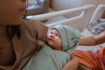 A serene moment of a newborn cuddled in a loving mothers arms, showcasing new life