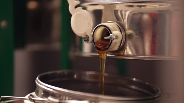 Honey pouring from extractor side angle