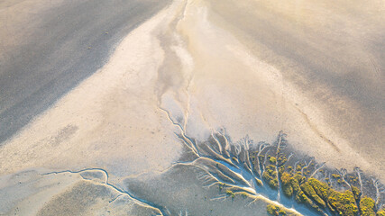 Creek and salt flats with green vegetation in beautiful pattern