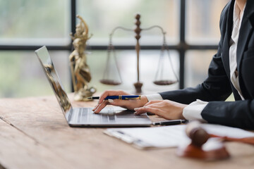 Lawyer Working on Laptop with Legal Symbols in Background 