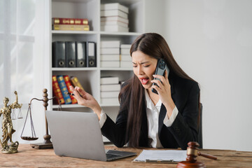 Lawyers Under Pressure: A focused woman in a lawyer's suit, phone pressed to her ear, gesticulating with intensity.  Her desk, with a laptop, legal documents, and a gavel.