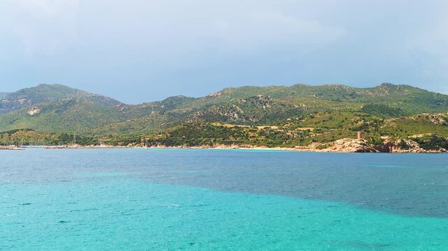 Torre del Budello watchtower tower by Teulada marina with boats landscape mountain view on Sardinia island, Italy by Mediterranean sea
