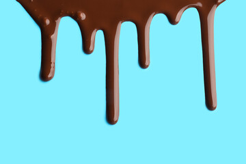 Sweet chocolate splash on blue background