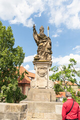 Obraz premium Sculpture of St Augustine by Hieronymus Kohl on the Charles Bridge in Prague in Czech Republic