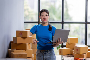 Entrepreneur startup SME business asian woman holding laptop. Small Online Business Online...